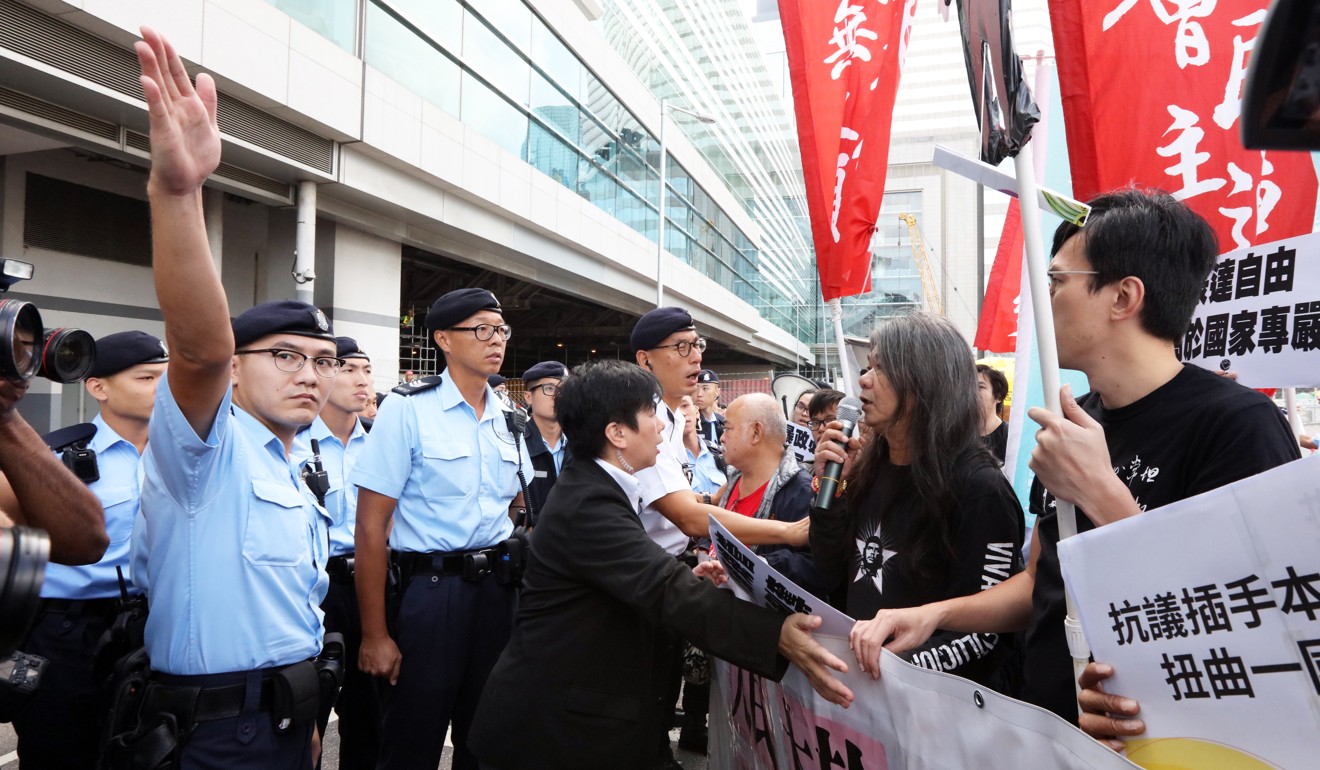 League of Social Democrats members, including Leung Kwok-hung, protest against Deputy Secretary-General of the National People's Congress Li Fei . Photo: Felix Wong