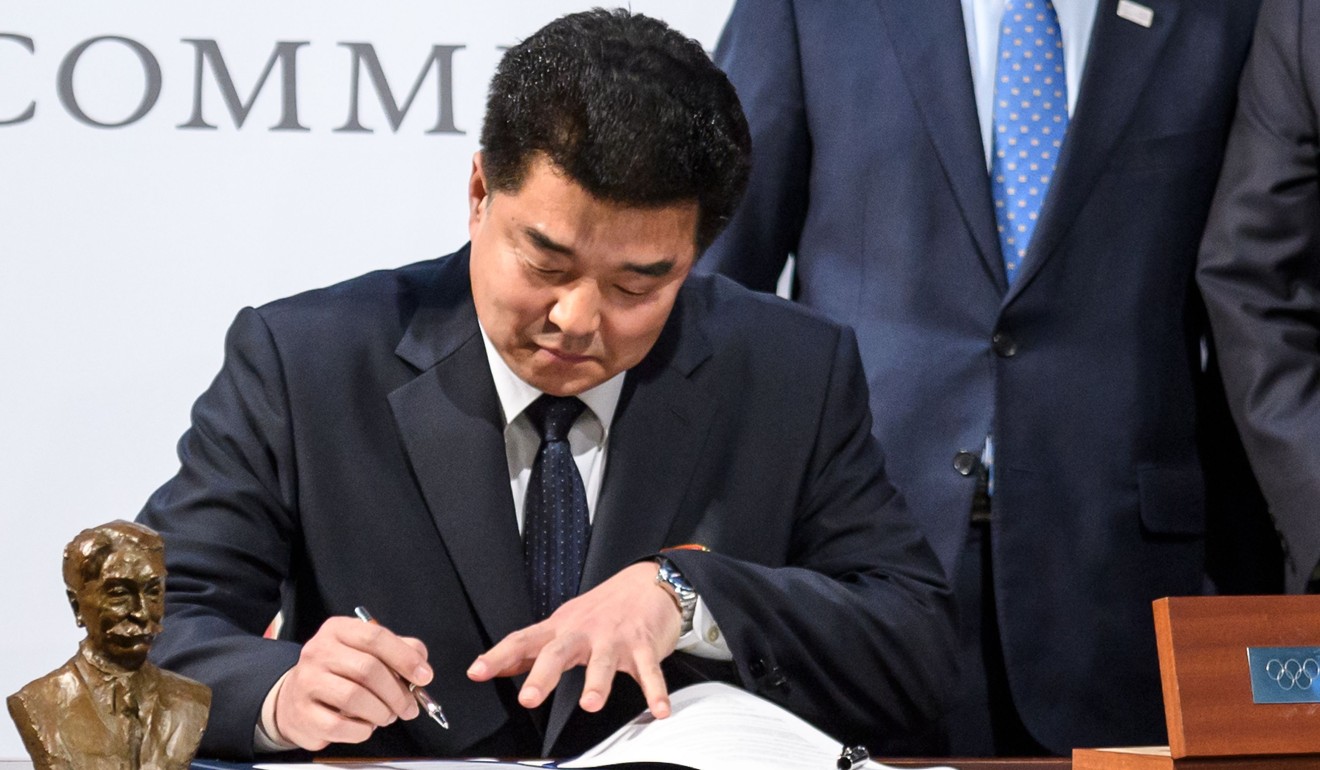 North Korea's Sports Minister Kim Il-guk signs an agreement at the IOC office in Lausanne. Photo: AFP
