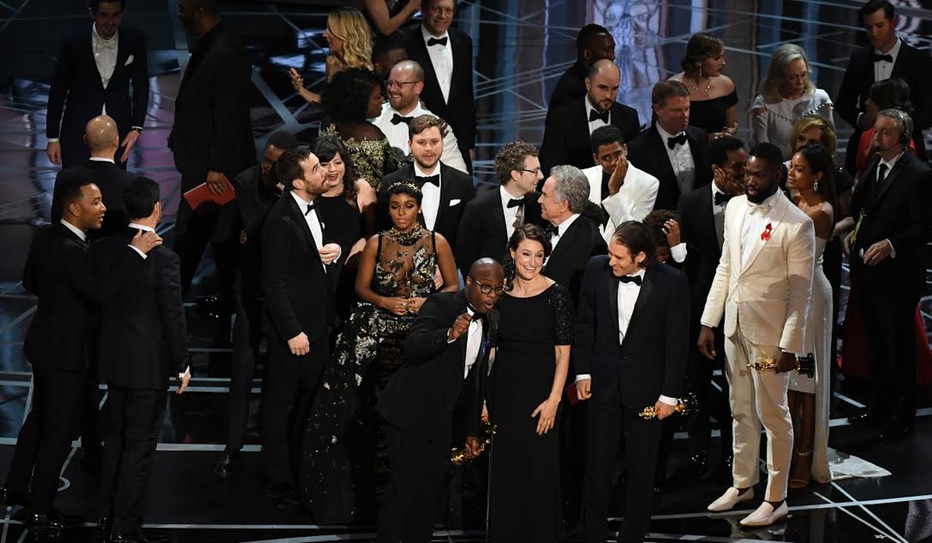 Moonlight director Barry Jenkins (centre) celebrates on stage with the cast and crew of the film after the correct result is read out. File photo: AFP