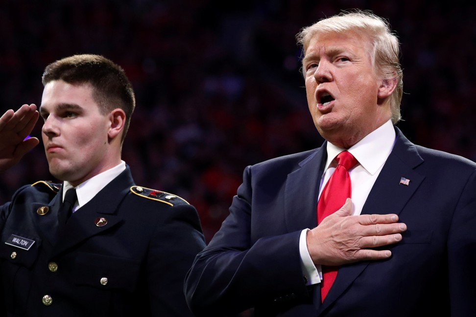 Donald Trump sings along with the national anthem before the NCAA College Football Play-off Championship game between Alabama and Georgia. Photo: Reuters