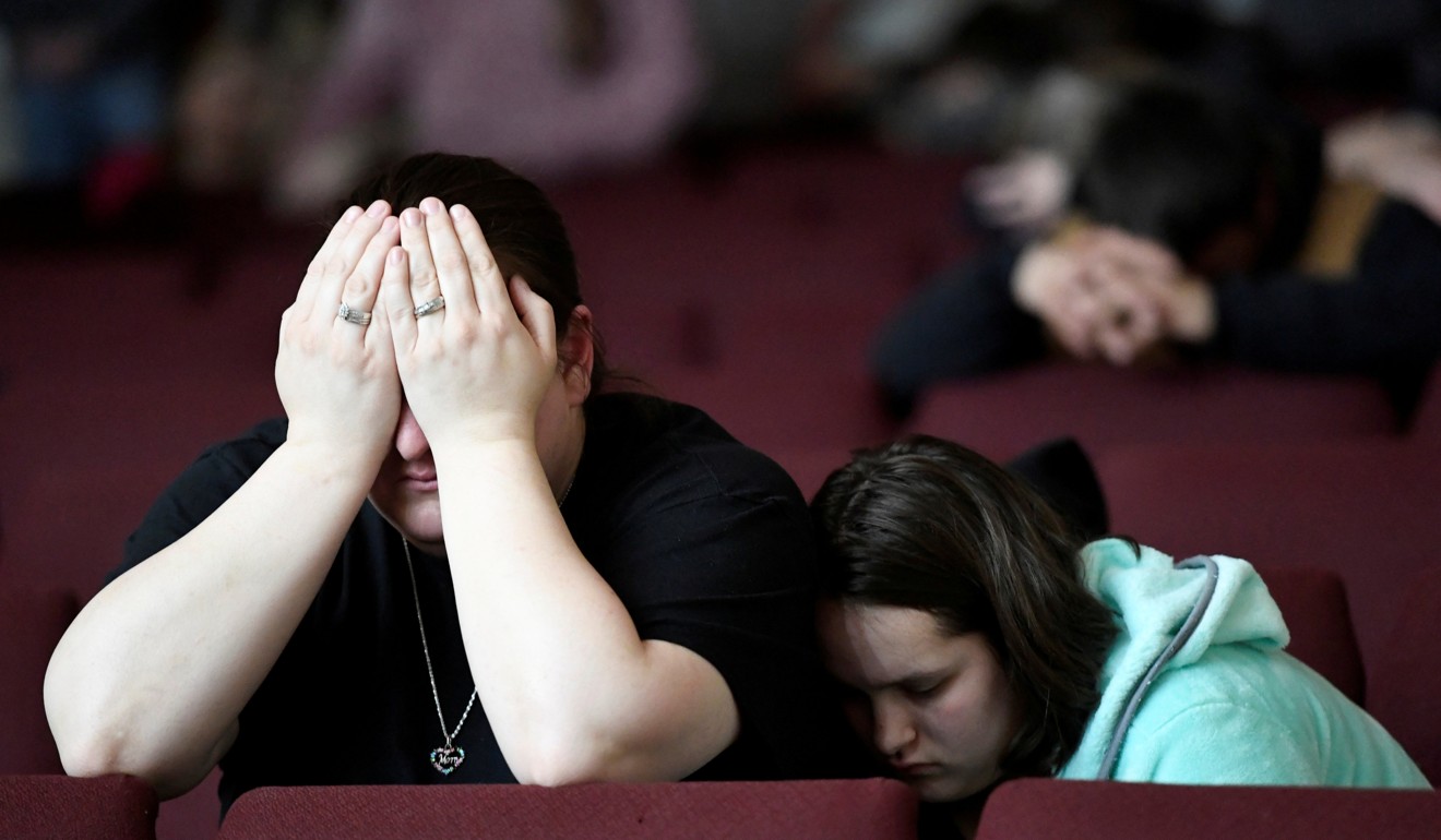Tiffany Moreland and her daughter Emily Moreland attend a prayer vigil for students killed and injured after a 15-year-old boy opened fire with a handgun at Marshall County High School, at Life in Christ Church in Marion, Kentucky, on Tuesday. Photo: Reuters