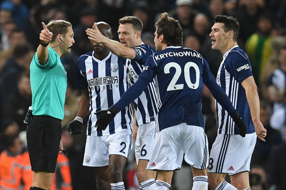 West Brom players argue with referee Craig Pawson after he gives Liverpool a penalty after consulting the VAR. Photo: AFP