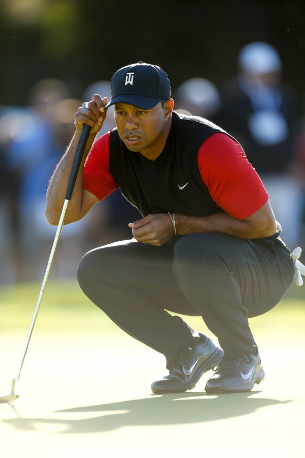 Woods looks over a putt on the 11th hole. Photo: AFP
