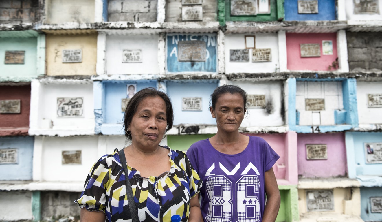 Loreta Vento (left) and Teresita Garces at the North Caloocan cemetery in Manila. Both had to bury their brothers who were killed as part of Duterte’s war on drugs. Photo: Zigor Aldama