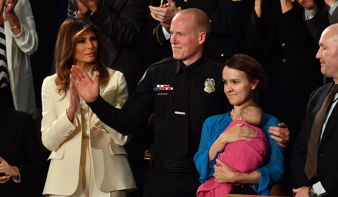 US first lady Melania Trump (left) applauds police officer Ryan Holets (centre) and his wife Rebecca, who adopted the baby of a heroin addict. The couple were recognised during US President Donald Trump’s state-of-the-union speech. Photo: AFP