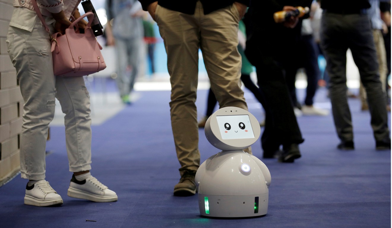 Visitors stand around a robot at the Global Mobile Internet Conference in Beijing in April 2017. European decision-makers are concerned about European know-how migrating to China as a result of the Chinese firms’ vast presence in Europe. Photo: Reuters