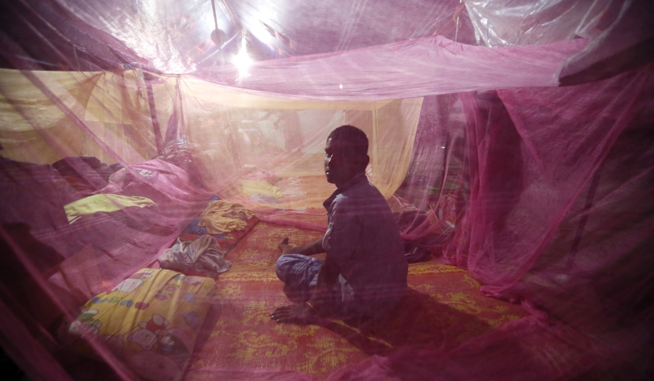 A man sits inside a mosquito net in East Aceh, Indonesia. Urgent action must be taken to stop the spread of drug-resistant malaria in Southeast Asia and potentially beyond, according to scientists. Photo: EPA