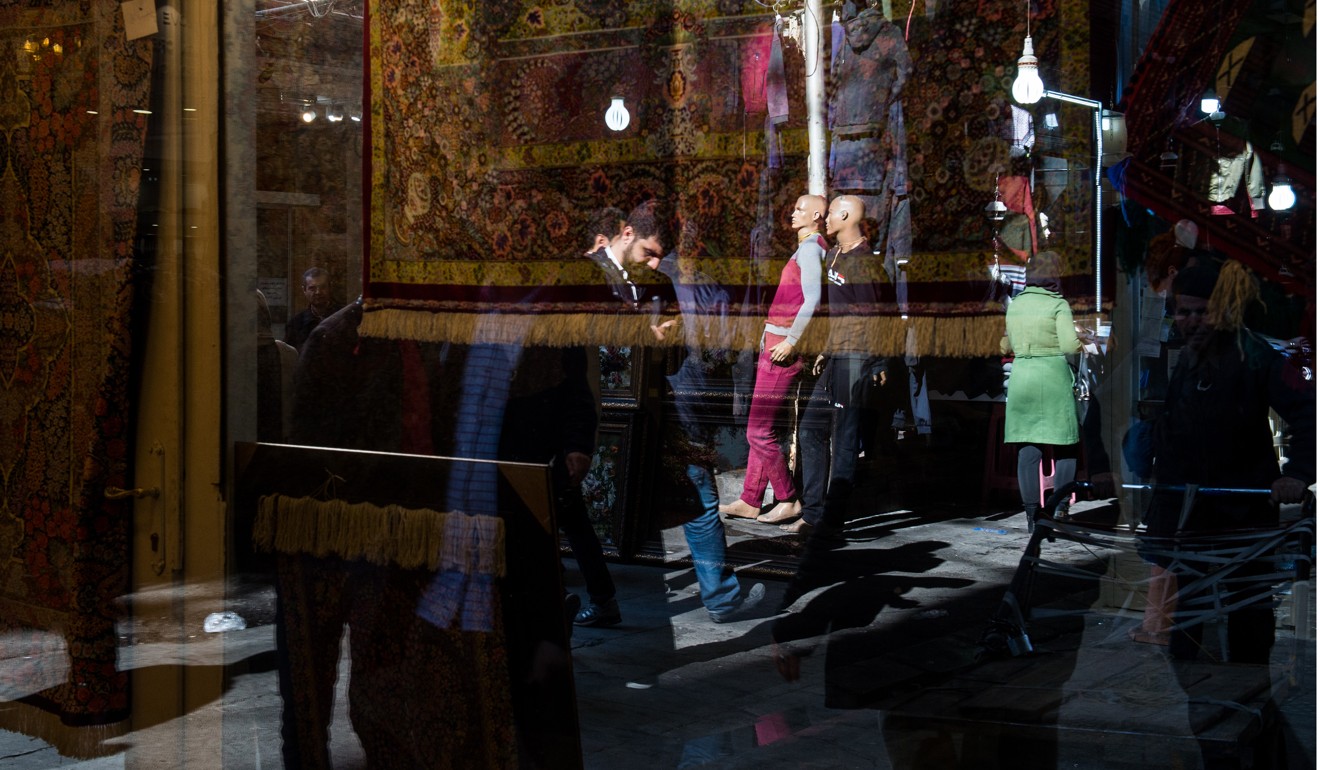 Shoppers visit the rug bazaar in Tehran, Iran, in January. Iran has been possibly the trickiest country in which to invest over the past couple of decades. Even so, a number of Western companies managed to do so and operate in the country, and have been rewarded with a good return on their investments. Photo: Bloomberg