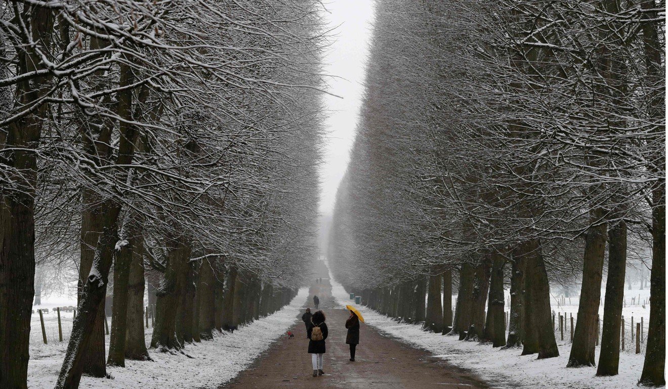People walk through the snow-covered Gardens of Versailles on Tuesday. Photo: Agence France-Presse