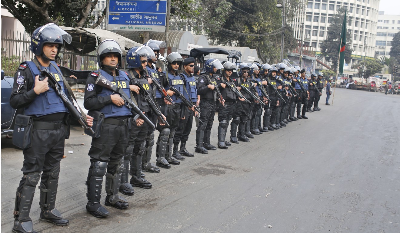 Soldiers of Rapid Action Battalion of Bangladesh stand guard on a street in Dhaka. Photo: AP