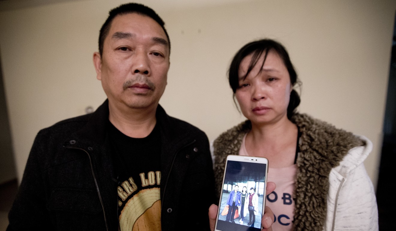 Zhang Ronggao, left, and Ye Lifeng display a photo them with their missing daughter, Zhang Yingying. Photo: AP