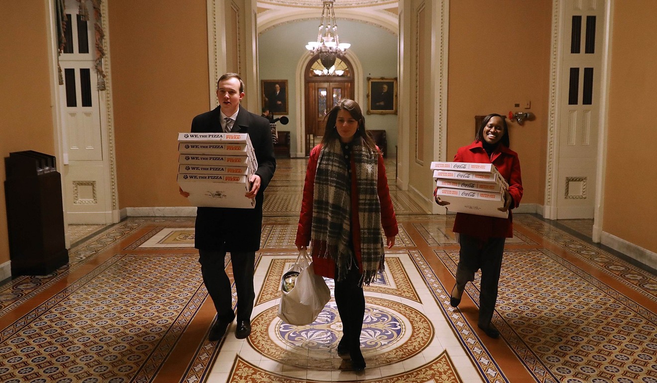 In anticipation of a late night, pizzas are carried to the offices of Senate Majority Leader Mitch McConnel in the US Capitol on February 8, 2018. Photo: AFP