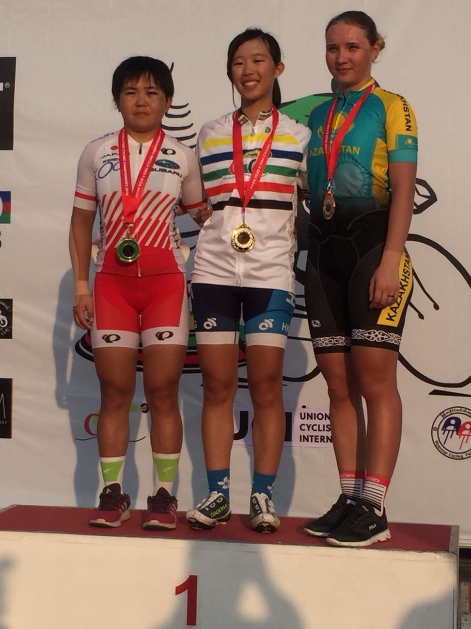 Hong Kong's Vivien Chiu stands on top of the podium after winning the women’s junior race in Myanmar.