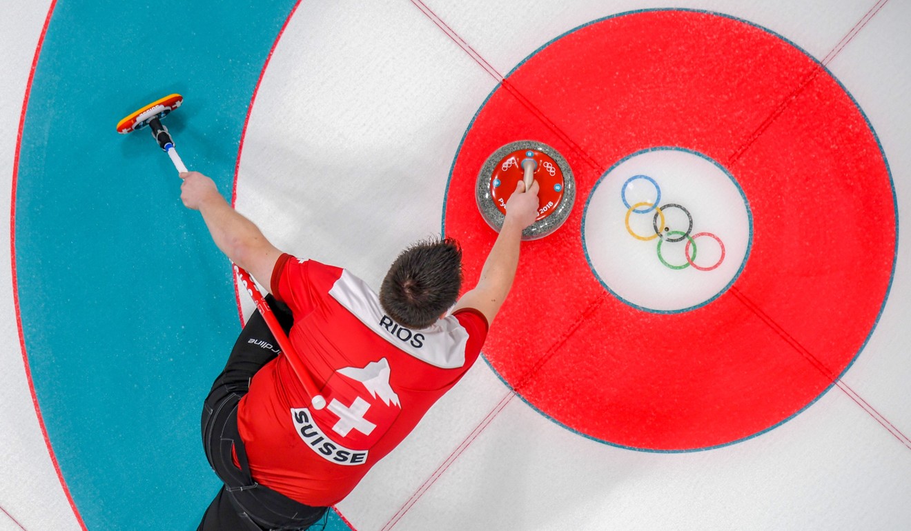 Switzerland's Martin Rios competes during the curling mixed doubles round robin session between Switzerland and South Korea. Photo: AF