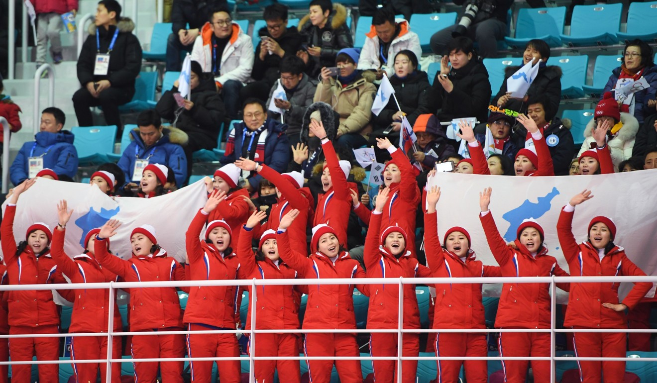 North Korea's cheerleaders hold the Unified Korea flag and cheer during the match. Photo: AFP