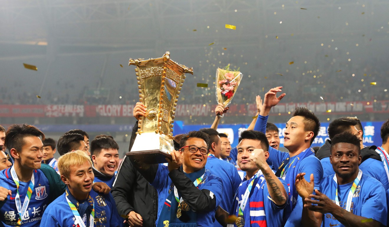Shanghai Shenhua coach Wu Jingui holds the Chinese FA Cup after beating city rivals SIPG in the final. Photo: AFP