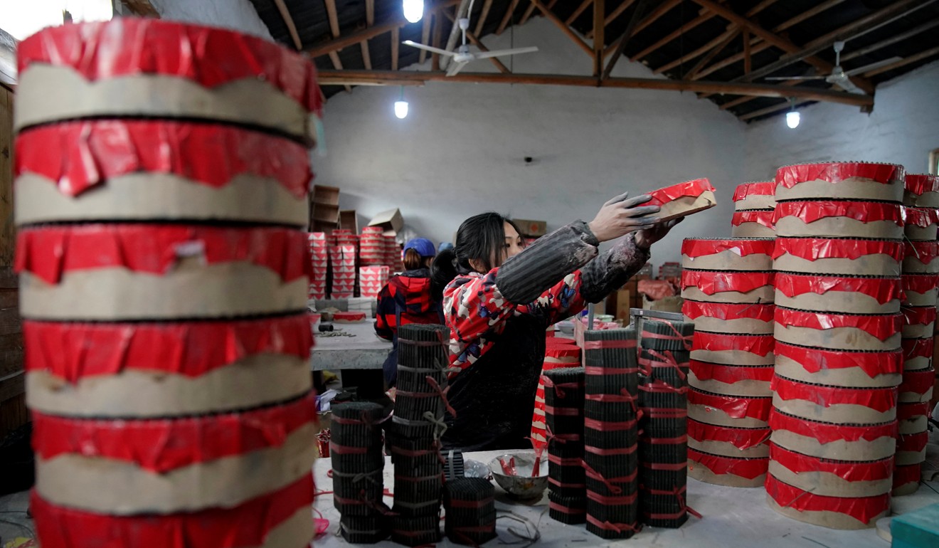 A worker processes pyrotechnic product at the Liuyang Standard Fireworks factory in Liuyang, Hunan province. Photo: Reuters