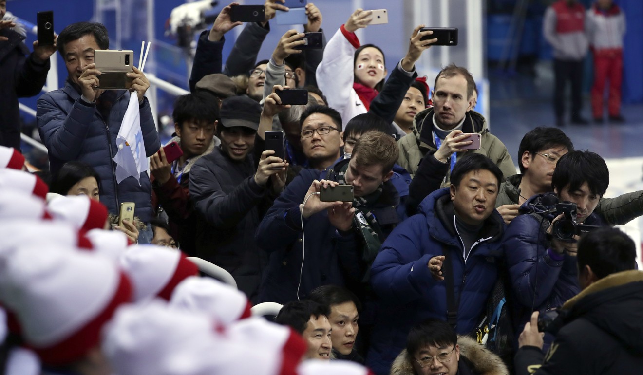 Fans scramble for pictures of the North Korea cheer squad. Photo: AP