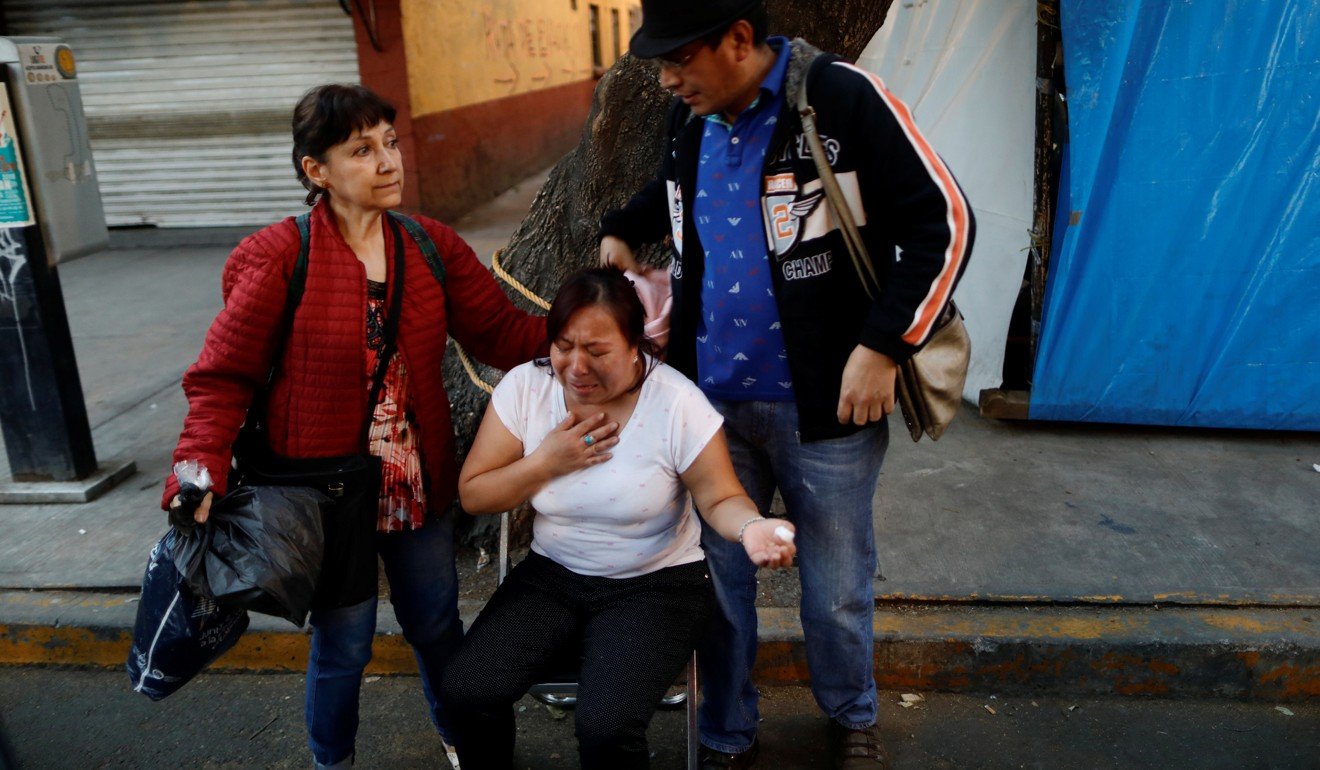 People react after an earthquake shook buildings in Mexico City. Photo: Reuters
