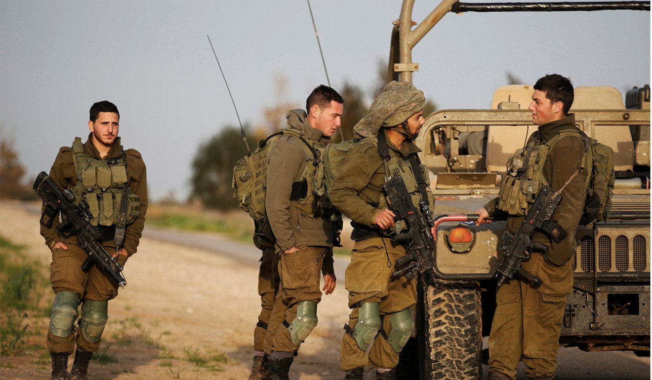 Israeli soldiers stands near a military jeep next to the border fence with the southern Gaza Strip near Kibbutz Nirim, Israel on February 17, 2018. Photo: Reuters