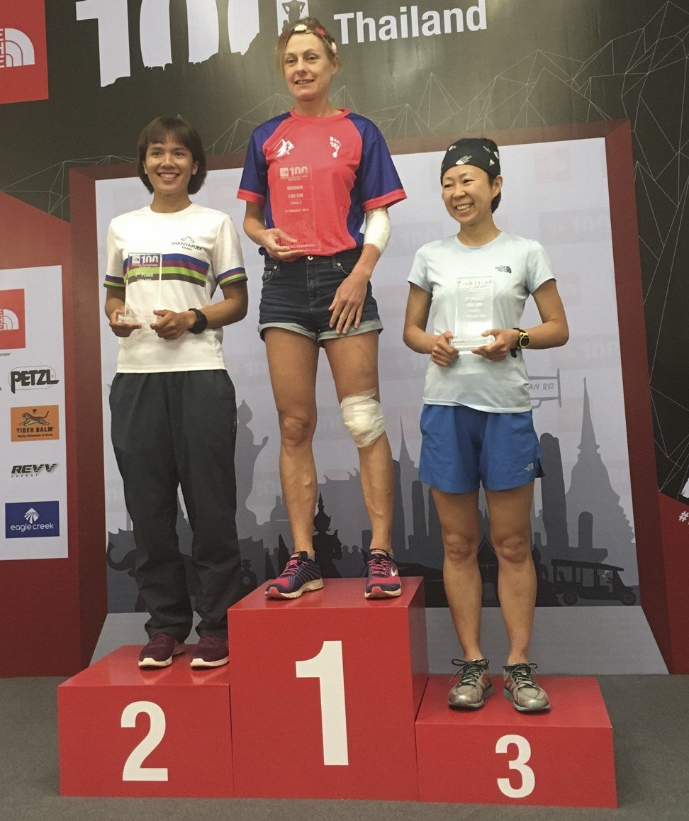 Carole Fuchs (centre) celebrates winning The North Face 100km in Nakhon Ratchasima province, Thailand. Photo: Blair McBride