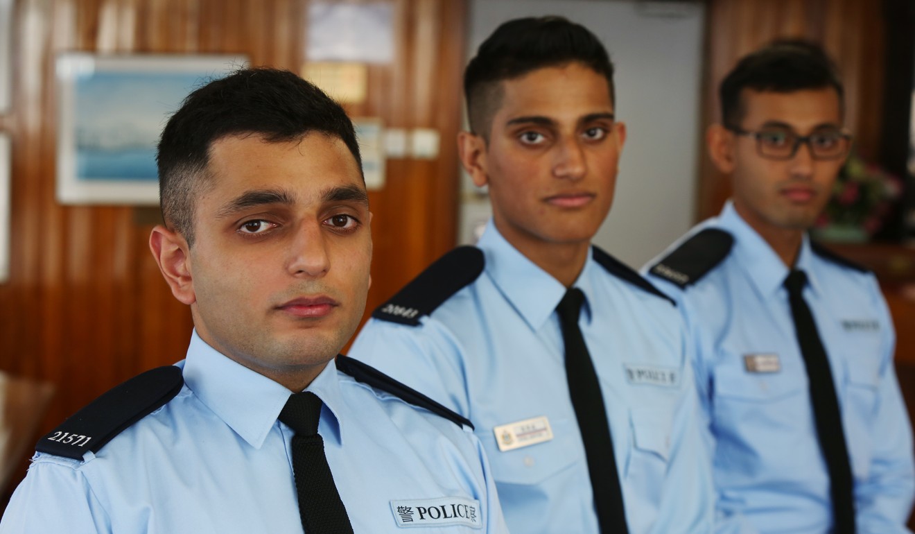 Police officers from the ethnic minority community pose for a photo at Tsim Sha Tsui police station. The police, correctional services and immigration are some of the civil service departments that court Hong Kong graduates of prestigious mainland universities. Photo: Xiaomei Chen
