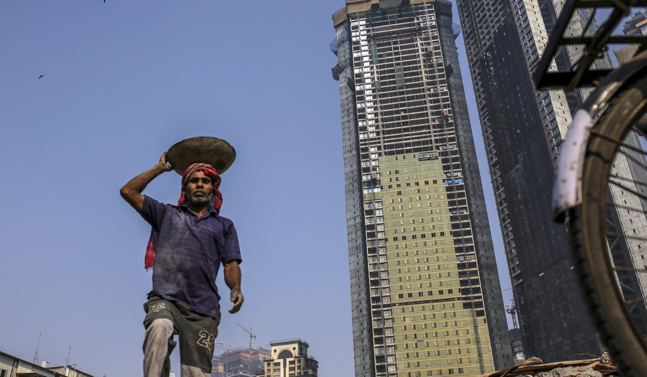A worker labours as the two towers of Trump Tower Mumbai stand under construction at Lodha The Park in Mumbai, India, on Tuesday, February 20, 2018. India has the most construction projects with Trump licensing deals of any country outside the US. Photo: Bloomberg