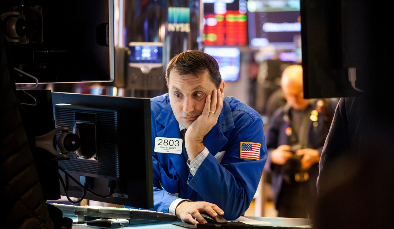 A trader works on the floor of the New York Stock Exchange. Outflows from US since the start of the year have risen to US$22 billion this year. Photo: Bloomberg