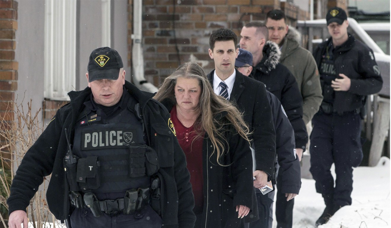 Forensic anthropologist professor Kathy Gruspier, second from left, walks with police officers at a property where alleged serial killer Bruce McArthur worked in Toronto, on February 8. Photo: AP