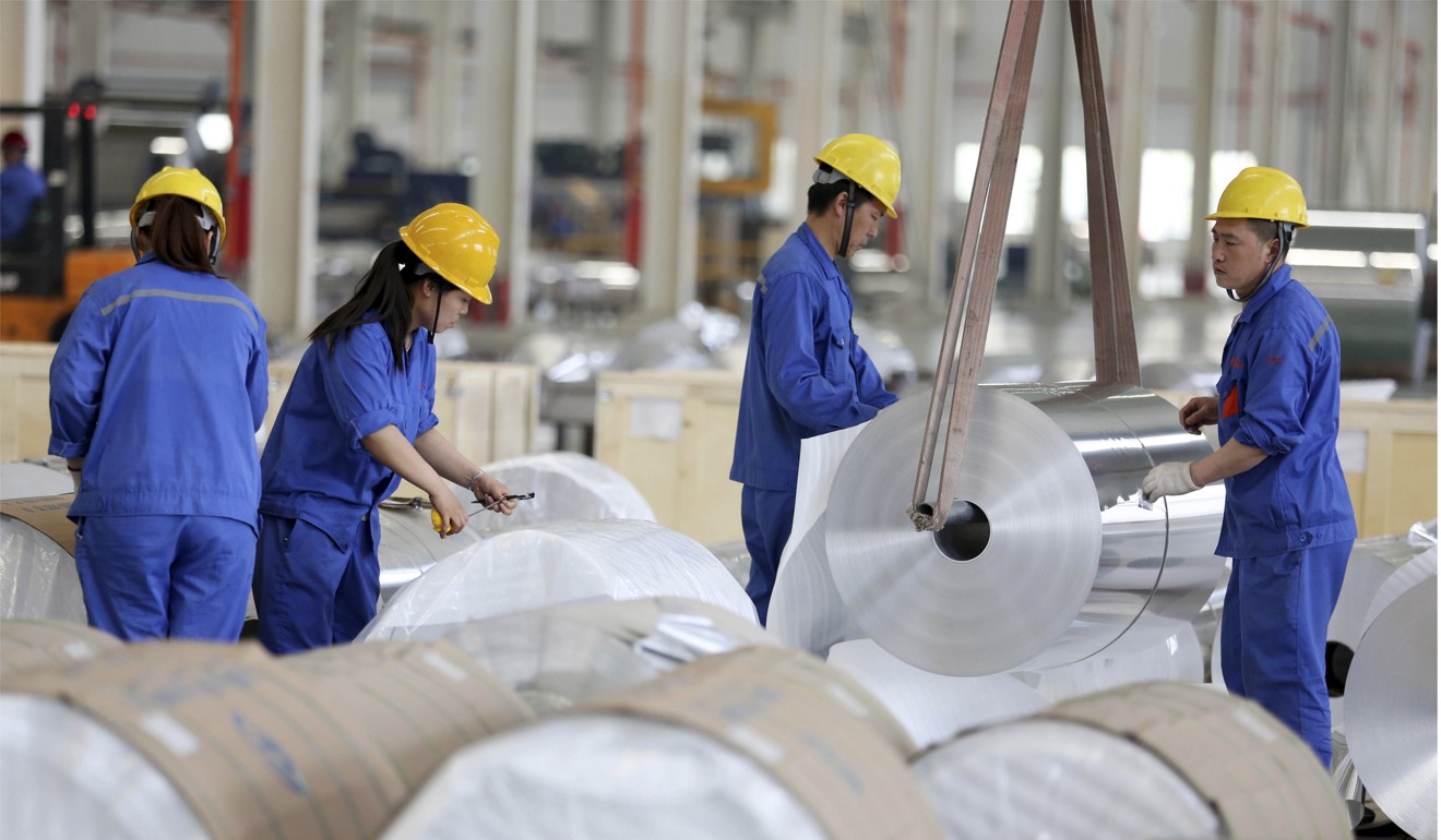 Chinese workers package aluminium tapes at an aluminium production plant in Huaibei, east China's Anhui province. Photo: AFP