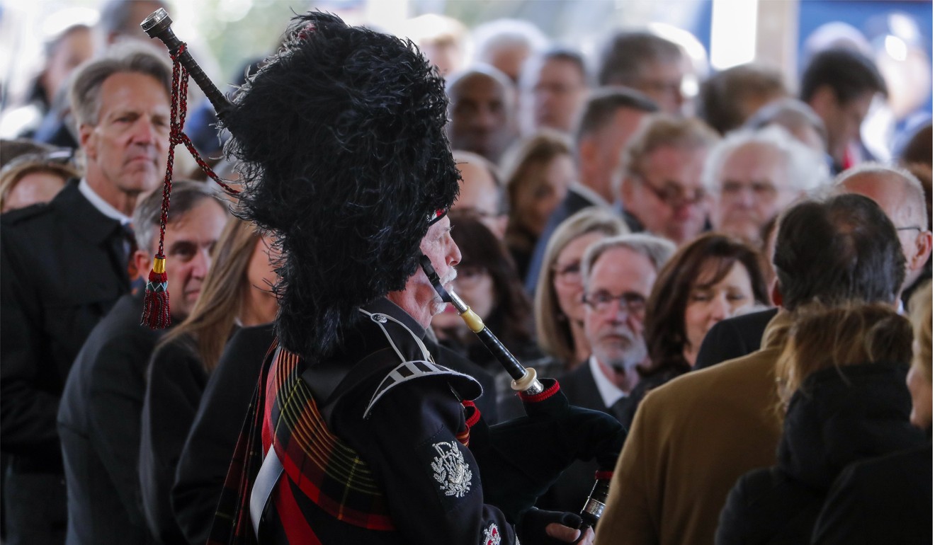 A bagpiper plays during the funeral service. Photo: EPA-EFE