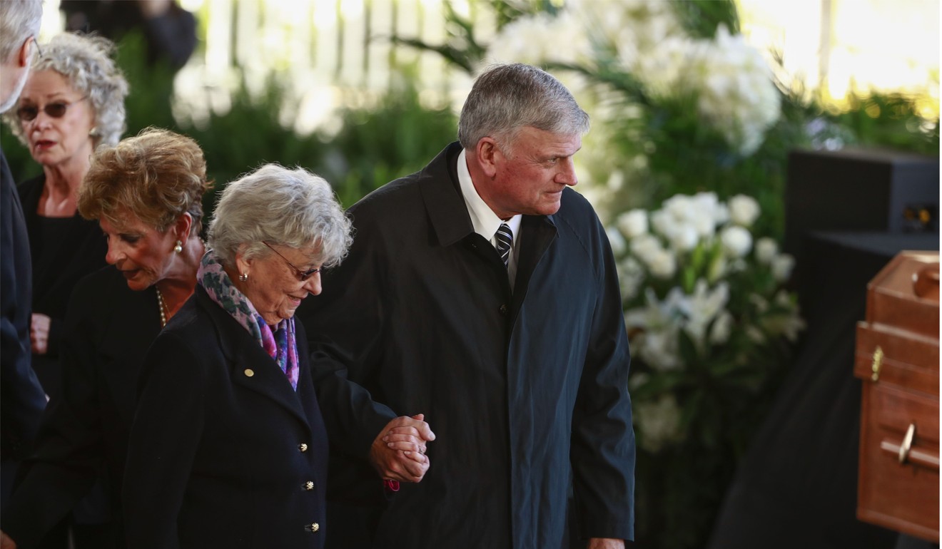 Franklin Graham, son of US evangelist Billy Graham, escorts relatives during the funeral servic. Photo: Reuters