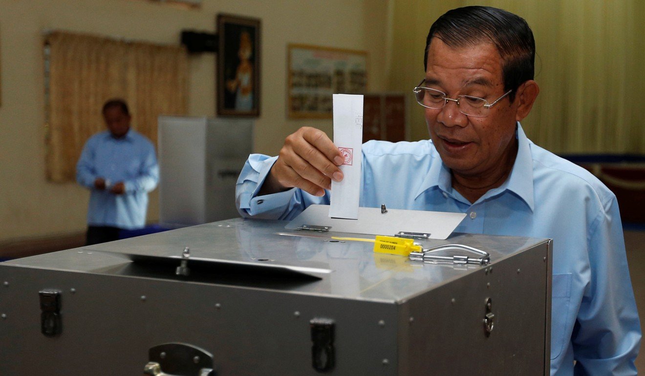 Hun Sen drops a ballot into a box during a senate election in Takhmao, Kandal province. Photo: Reuters