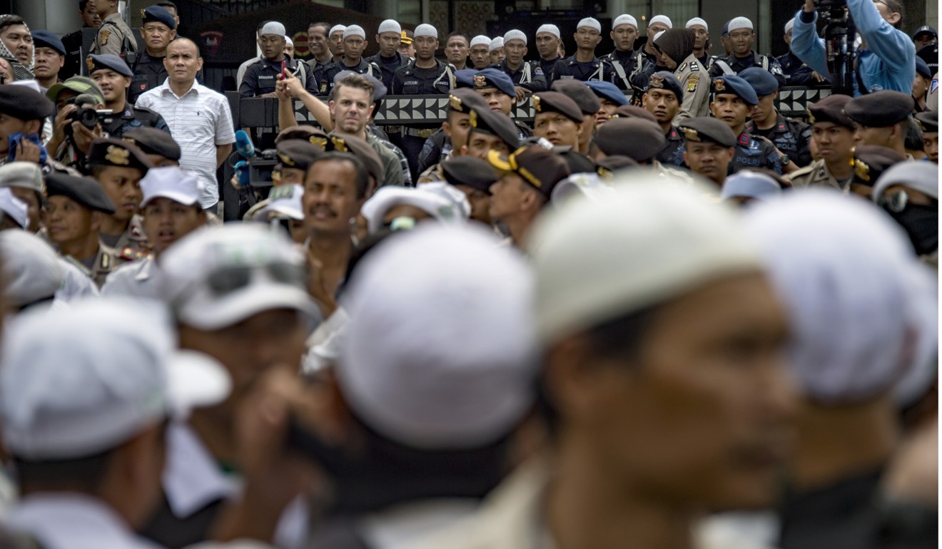 Police block the entrance to the Facebook office building during a January demonstration by a hardline Islamist group in Jakarta. Photo: AFP