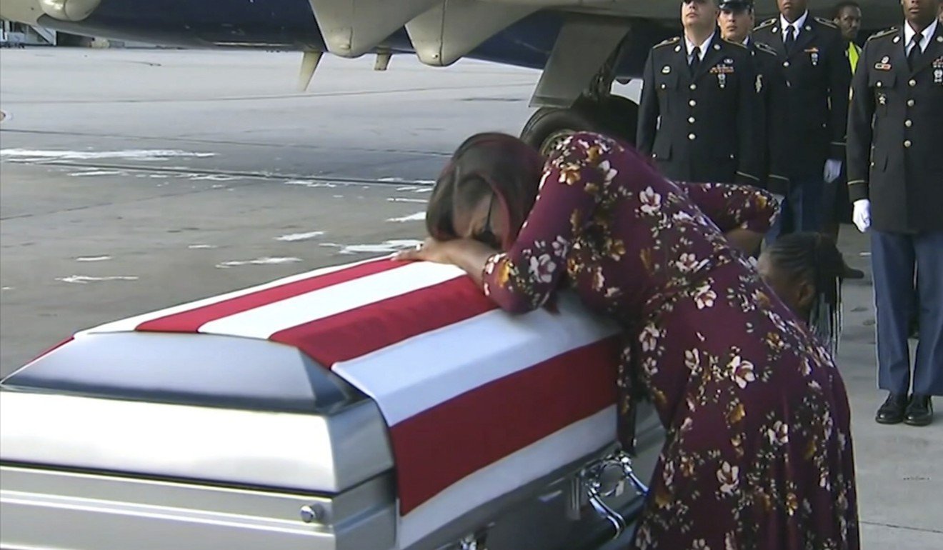 In this October 17, 2017 image, Myeshia Johnson cries over the casket her husband, Sergeant La David Johnson, at Miami International Airport. Photo: AP