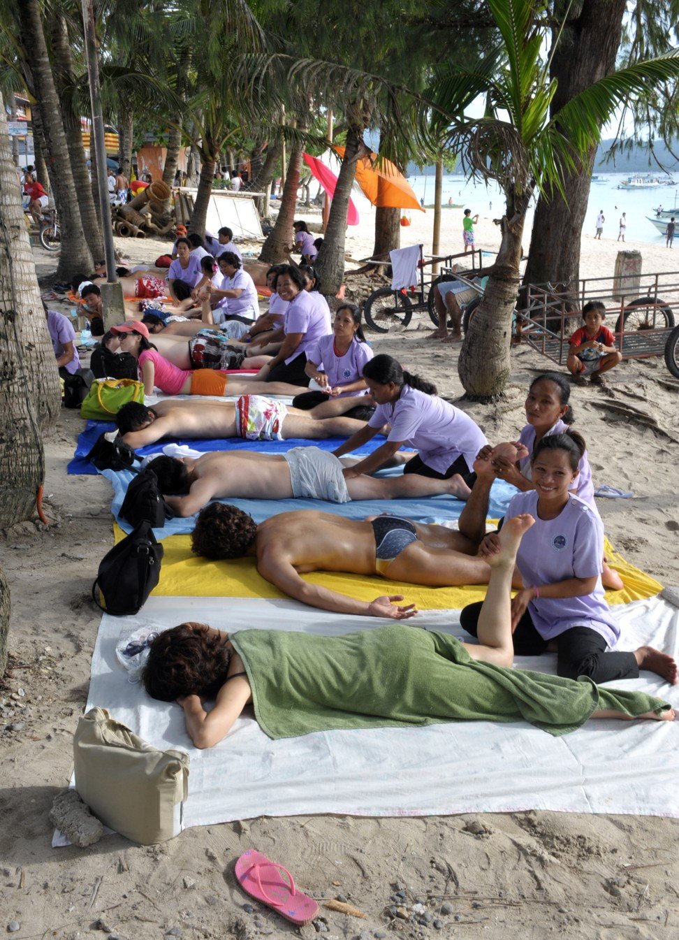 Tourists enjoy a massage on Boracay. Picture: AFP