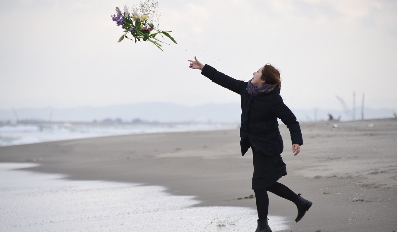 A mourner in Sendai marks the anniversary of the 2011 earthquake and tsunami. Photo: AFP