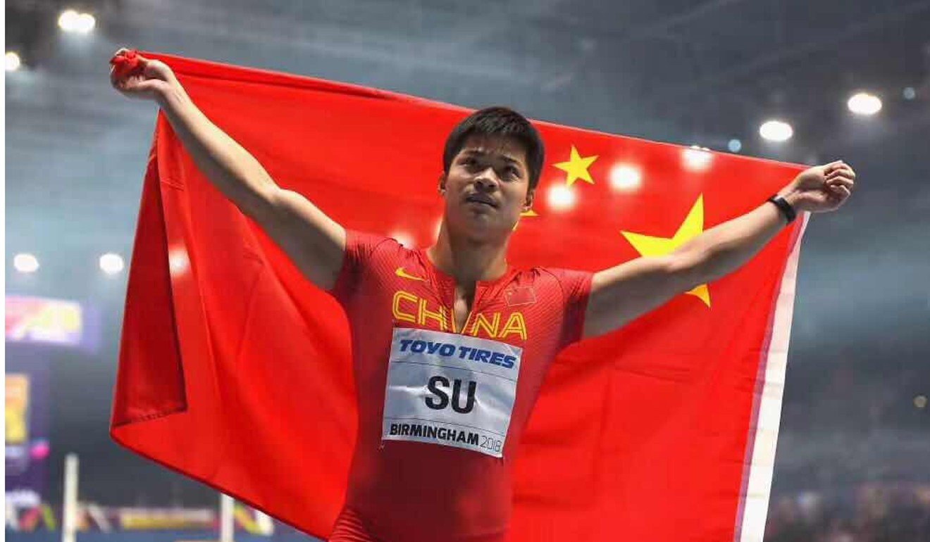Su Bingbian with the national flag after winning a silver medal at the 2018 World Indoors. Photo: Handout