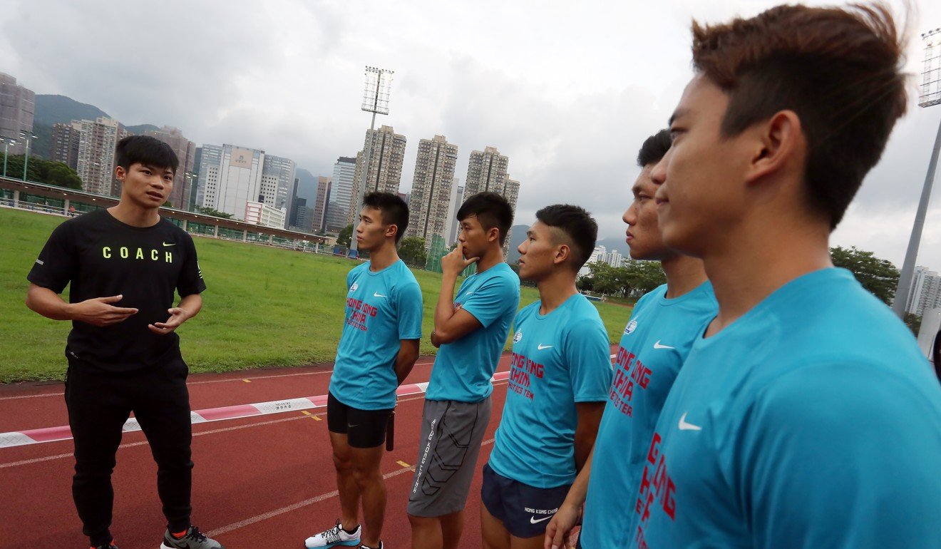 Sprinter Su Bingtian (left), the first Chinese to race under 10 seconds in the men's 100 metres, gives a clinic to members of the Hong Kong Boys 4x100 metres, at the Hong Kong Sports Institute in Fo Tan. Photo: Jonathan Wong