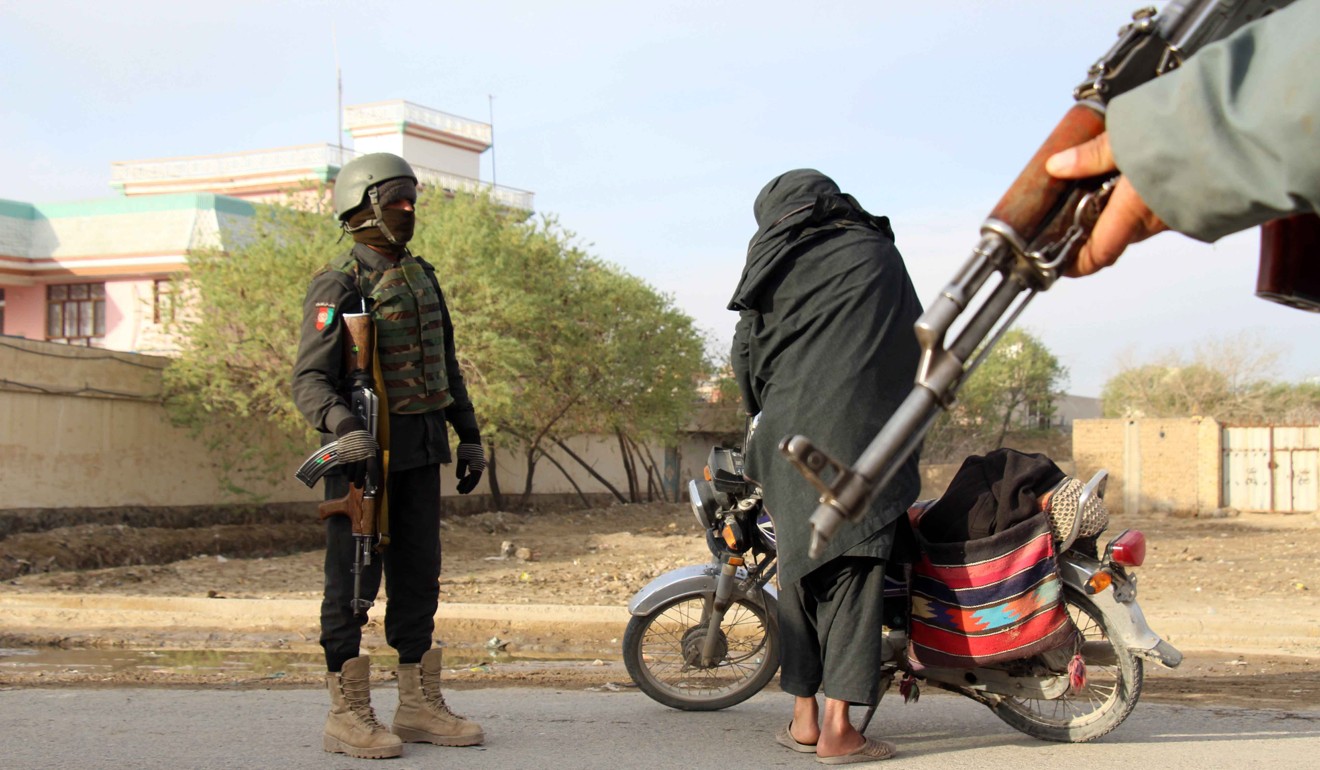 Afghan soldiers stopping people at a roadside check point in Kandahar. Photo: EPA
