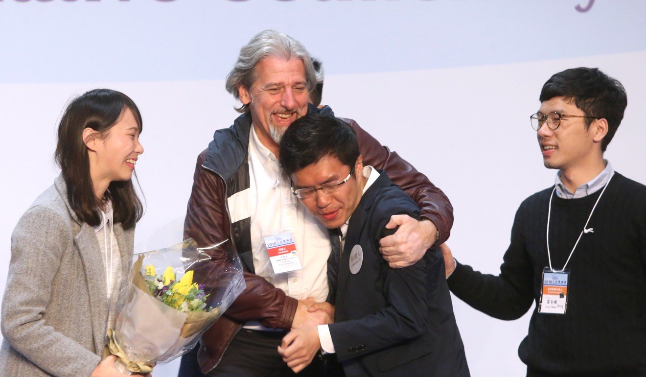 Au Nok-hin (centre) celebrates his win with Agnes Chow (left), Nathan Law Kwun-chung (right) and Paul Zimmerman (back). Photo: Sam Tsang