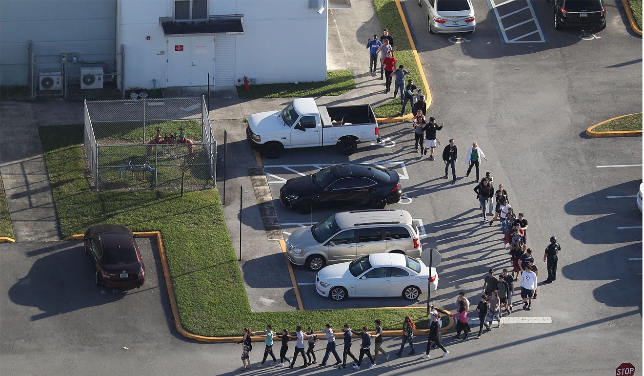 Pupils and teachers are taken out of the school on February 14. File photo: Getty Images North America via AFP