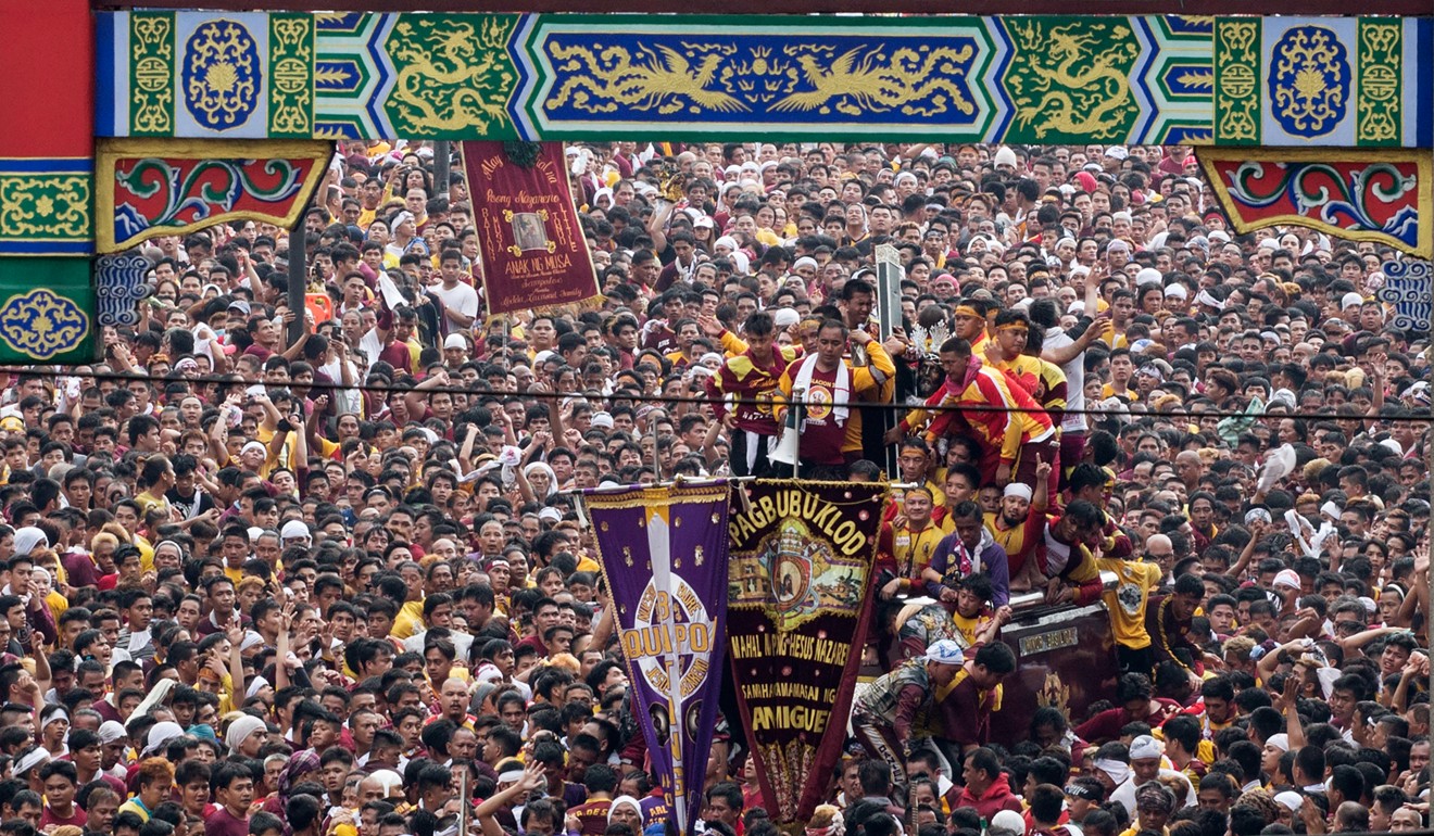 Devotees carry the statue of the Black Nazarene during the annual religious procession in Manila, Philippines. Picture: AFP