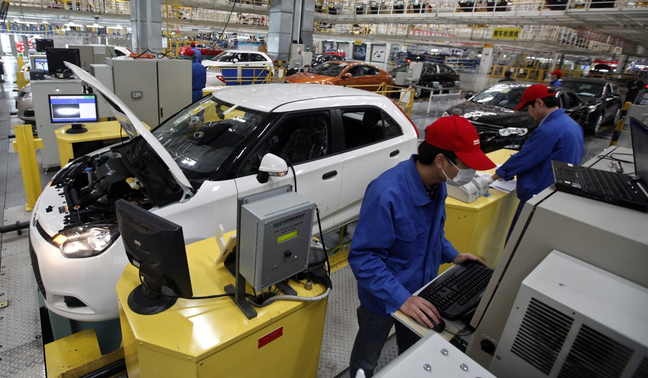 US companies such as General Motors, which partners with SAIC Motor in China, were the focus of a US government investigation of business practices forcing US companies operating in China to transfer technology to local business partners. Pictured: employees work on an assembly line at a SAIC factory in Shanghai. Photo: Reuters