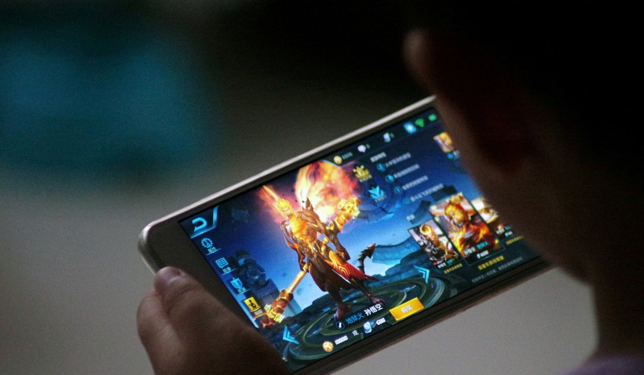 A child plays the game Honour of Kings by Tencent. Photo: REUTERS