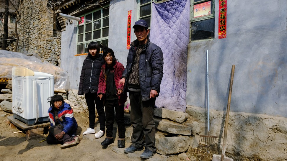 The Zhang family outside their home in the village of Xiaoguancheng, Hebei province. Photo: Lea Li
