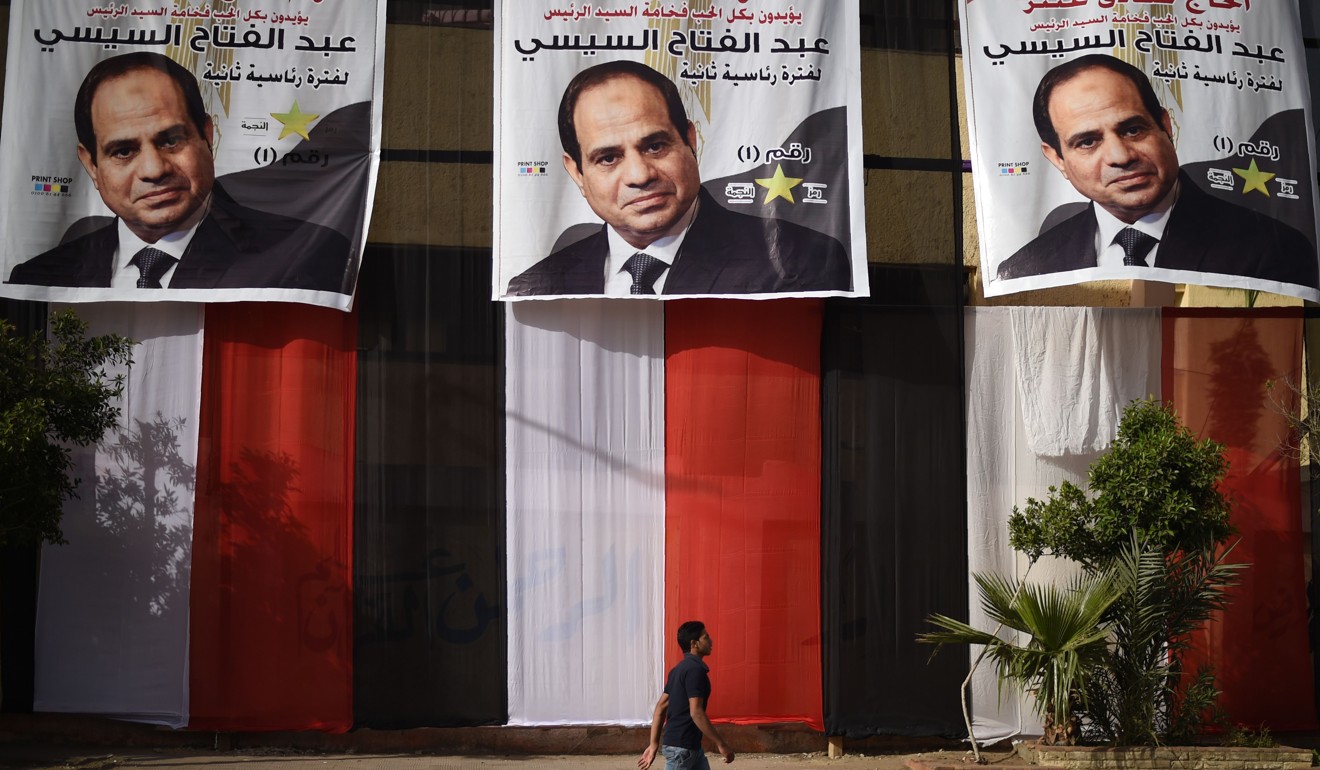 An Egyptian youth walks past a polling station in the capital Cairo's western Giza district. Photo: AFP