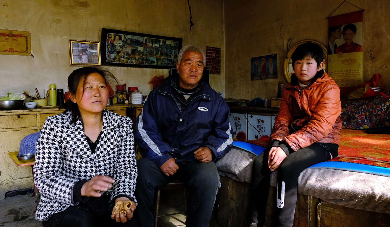 Zhang Yanli and Zheng Gang with their daughter, who studies at a boarding school in the township. Photo: Lea Li
