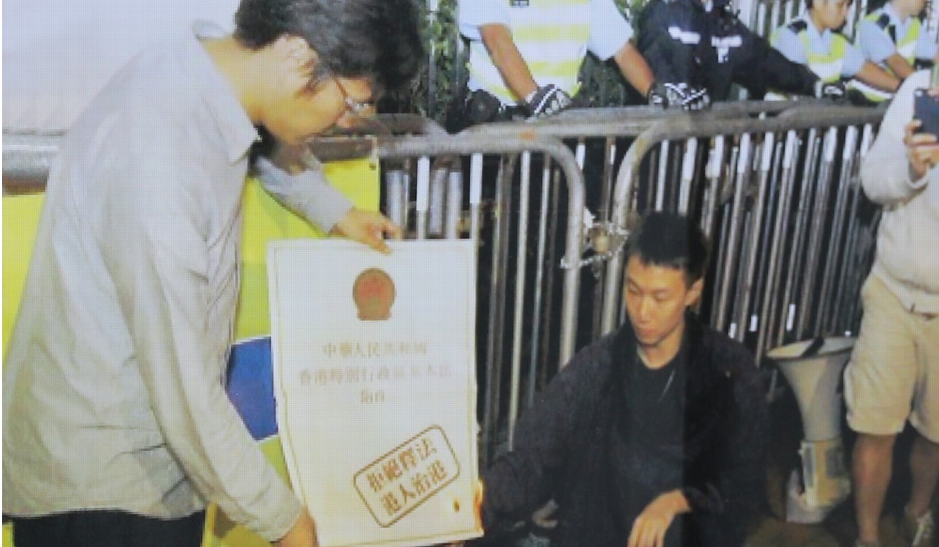 Au Lok-hin (left) took part in a rally where a copy of the Basic Law was burned. Photo: Handout