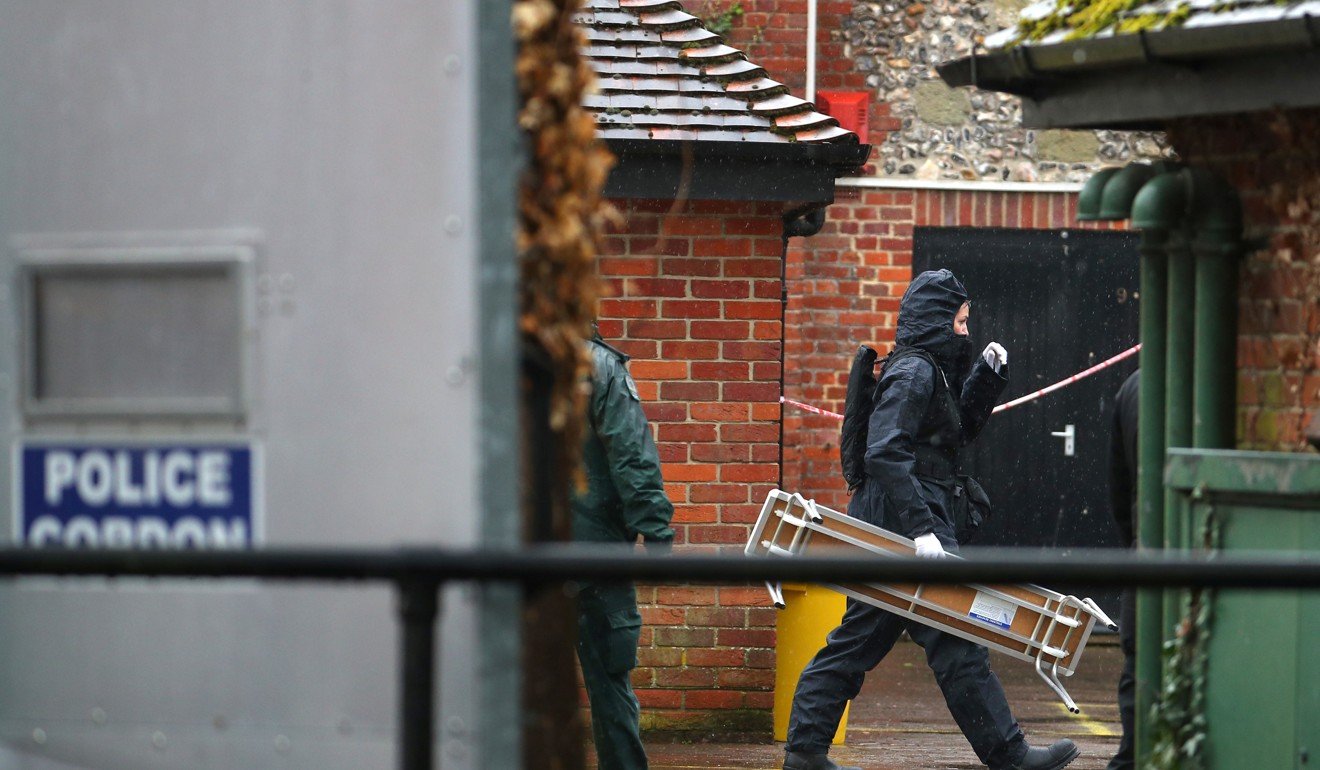 Police officers in protective inspect the area around The Mill public house, which had been visited by Sergei Skripal, in Salisbury before he was taken to hospital after being poisoned with a nerve agent. Photo: Reuters